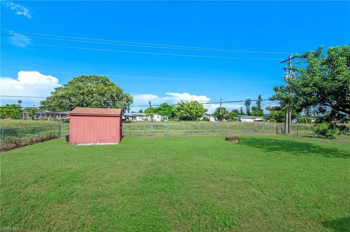 View of yard featuring a storage unit