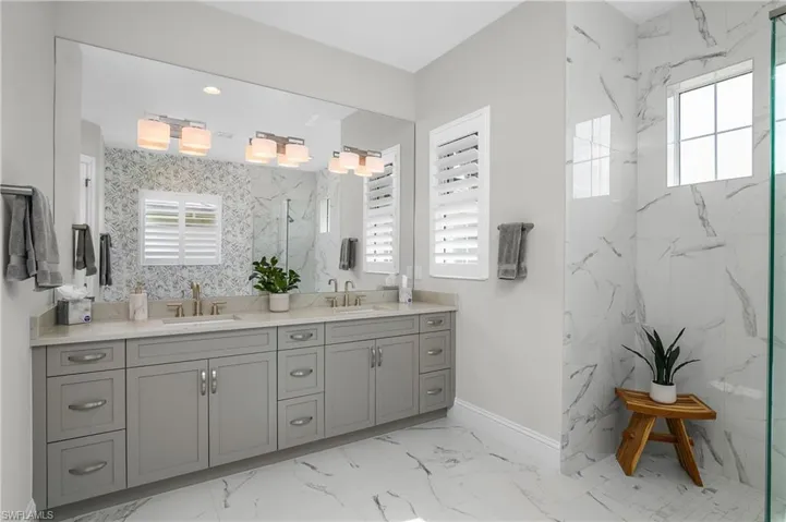 Bathroom with vanity and a tile shower