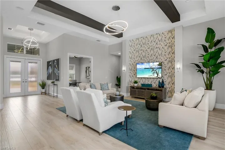 Designer lighting, with custom soaring ceiling and pillars make this room extra special.