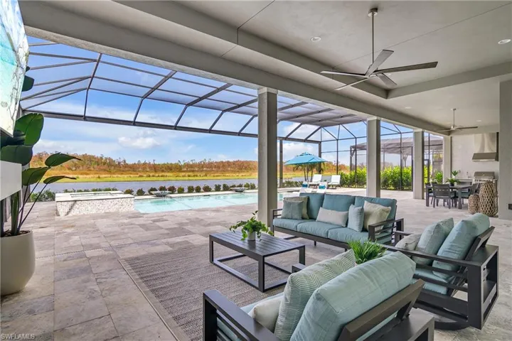 View of patio / terrace featuring a swimming pool with hot tub, outdoor lounge area, a lanai, a water view, and ceiling fan
