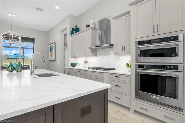Kitchen with upgraded Kitchen Aid appliances and custom cabinets with pull out drawers.