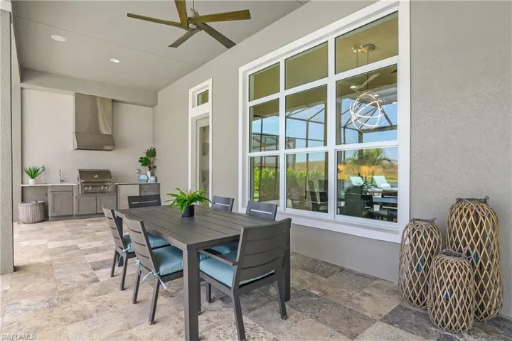 View of patio / terrace featuring ceiling fan, exterior kitchen, and a grill