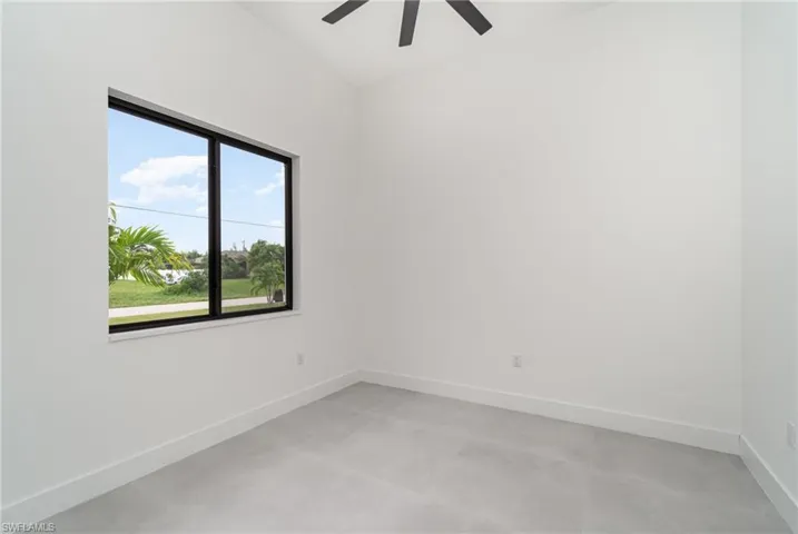 Spare room with a healthy amount of sunlight and ceiling fan