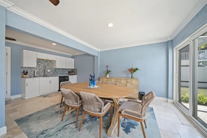 Dining space with a wealth of natural light and crown molding