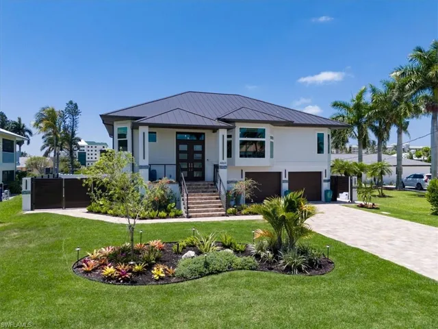 View of front of house with a front yard and a garage