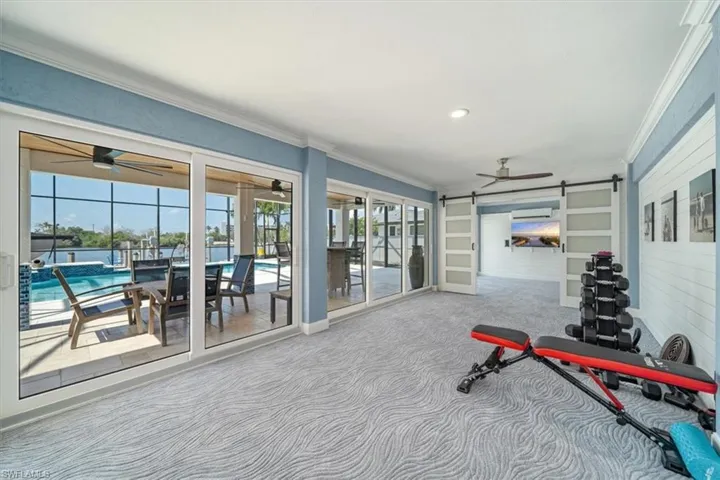 Workout room featuring crown molding, carpet flooring, and ceiling fan