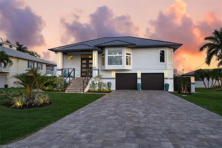 View of front of property with a lawn and a garage