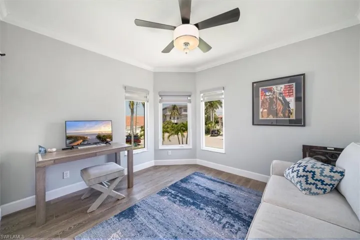 Home office featuring ornamental molding, hardwood / wood-style floors, and ceiling fan