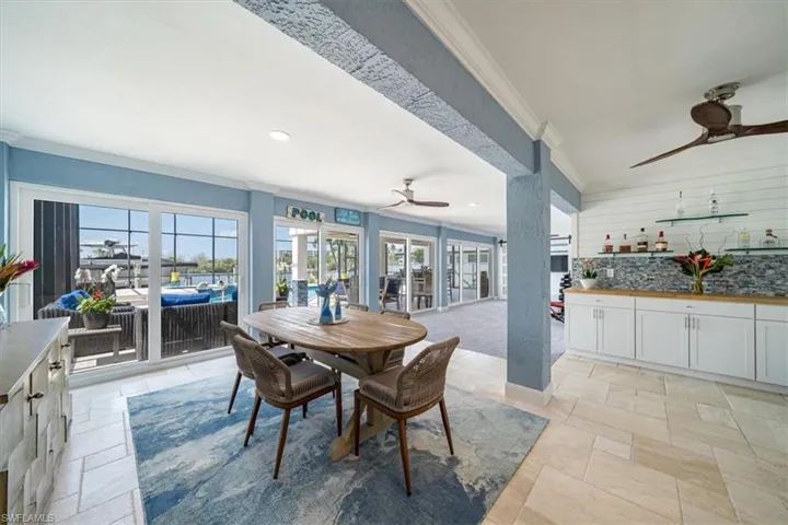 Dining area featuring ceiling fan, ornamental molding, and plenty of natural light