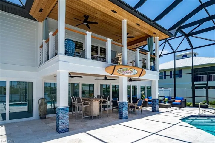 View of patio featuring an outdoor living space, glass enclosure, and ceiling fan
