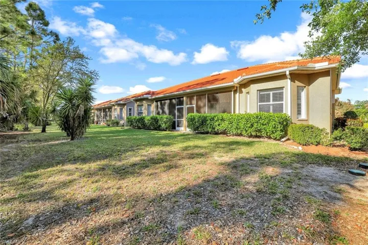 Back of property with screened lanai & view of preserve