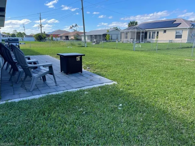 Fenced backyard with a patio and a residential view
