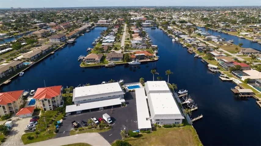 Birds eye view of property with a water view