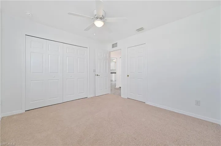 Guest bedroom with a closet, and ceiling fan