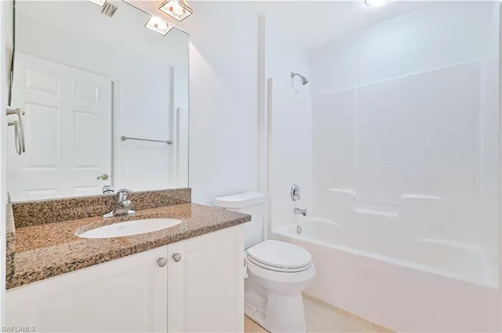 Full bathroom featuring vanity, tub / shower combination, toilet, and tile patterned flooring