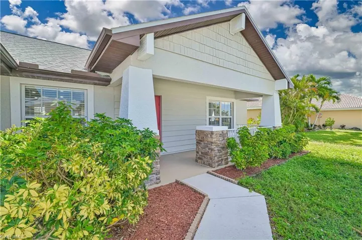 Doorway to property featuring a landscaped areas