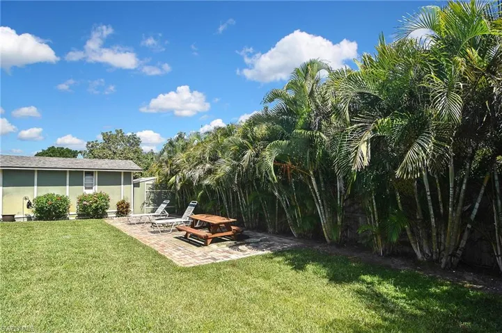 View of green lawn with a patio area
