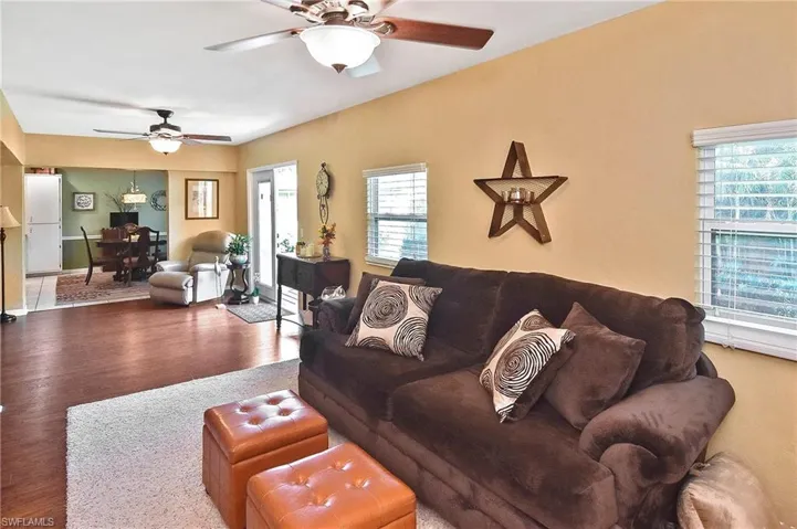 Living room with a ceiling fan and wood finished floors