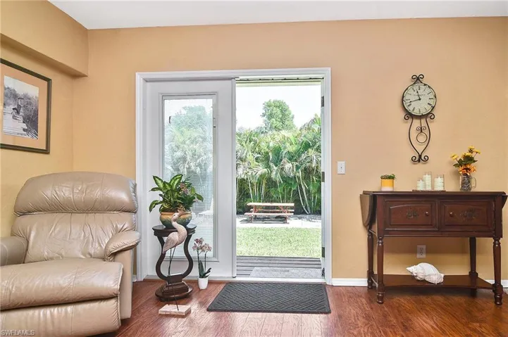 Entryway with dark wood-style floors and baseboards
