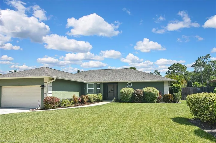 Ranch-style home with stucco siding, an attached garage, driveway, and a shingled roof
