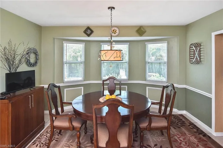 Dining area with plenty of natural light and wood finished floors