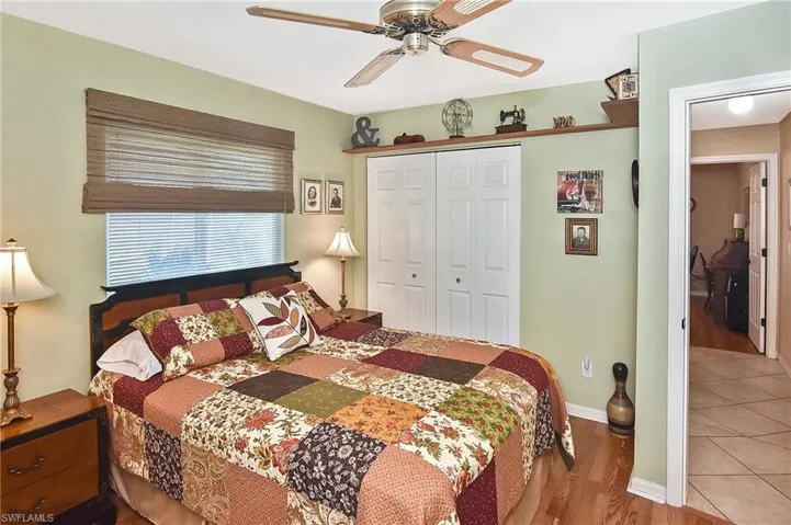 Bedroom with a closet, wood finished floors, and ceiling fan