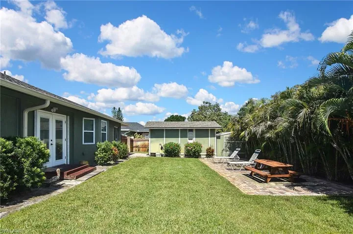 View of yard with french doors and a patio