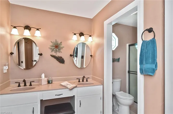 Full bath with double vanity and toilet