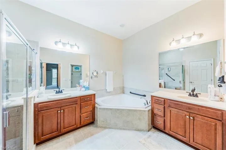Light and bright master bath with soaking tub and separate shower.