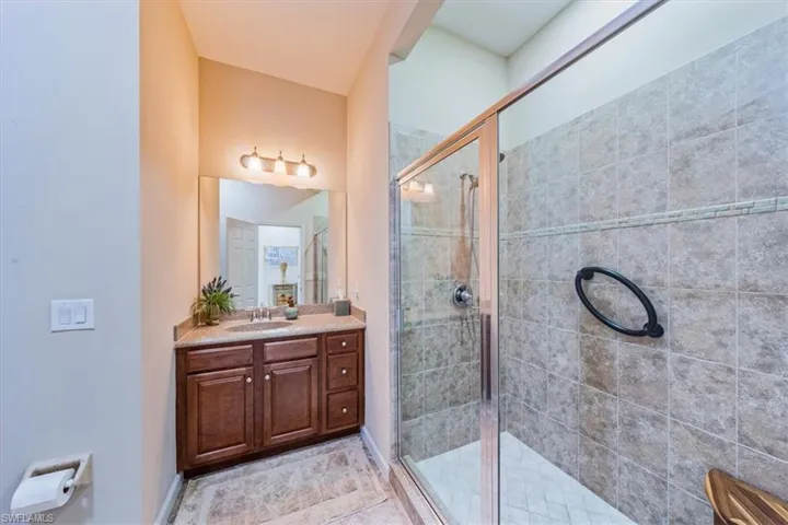 Guest bathroom w/walk-in shower and granite countertop.