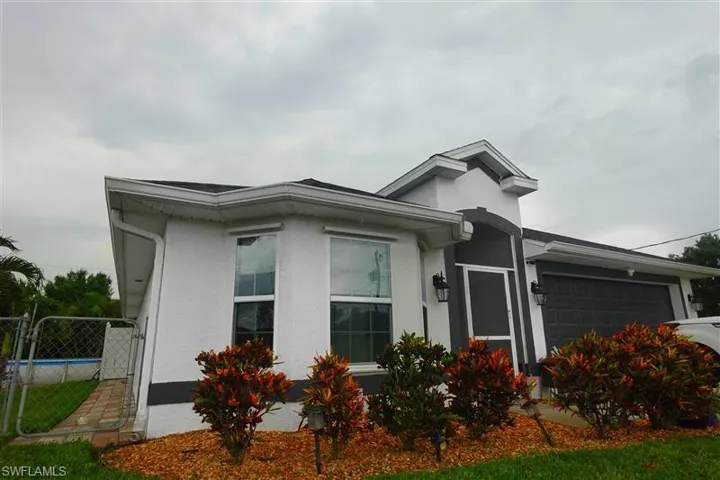 View of property exterior featuring a garage