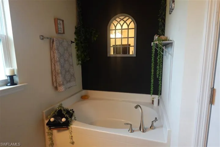 Bathroom with a tub and plenty of natural light