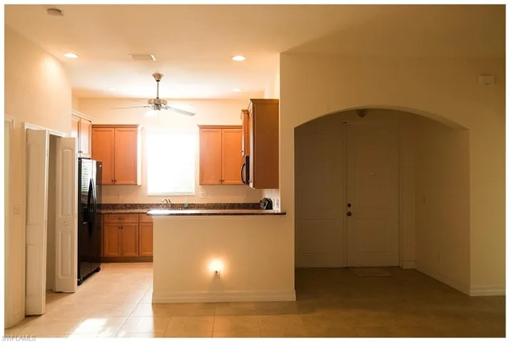 Kitchen featuring ceiling fan, sink, appliances with stainless steel finishes, and light tile patterned flooring