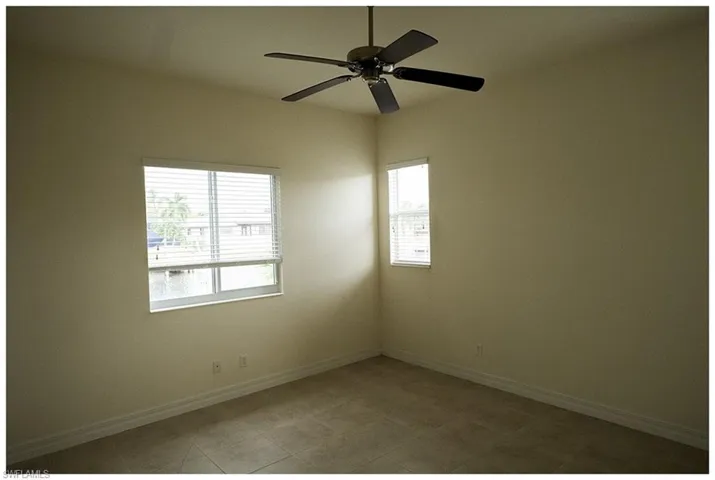 Empty room featuring ceiling fan