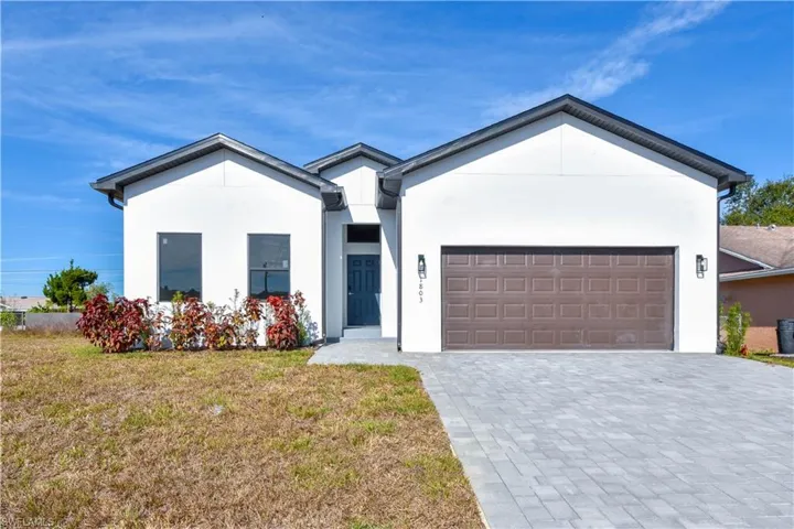 View of front of similar construction property with a front yard, decorative driveway, stucco siding, and an attached garage. Ext. Color may vary