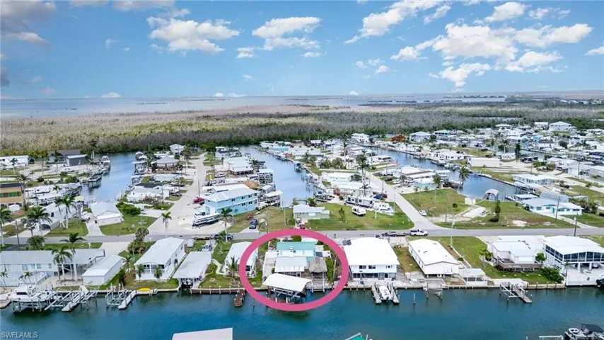 Aerial perspective of suburban area with a nearby body of water