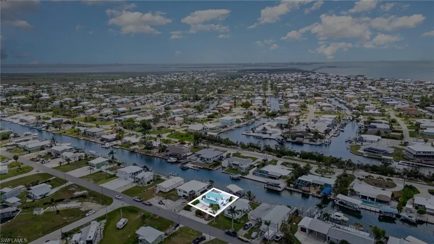 Aerial overview of property's location with nearby suburban area and a nearby body of water
