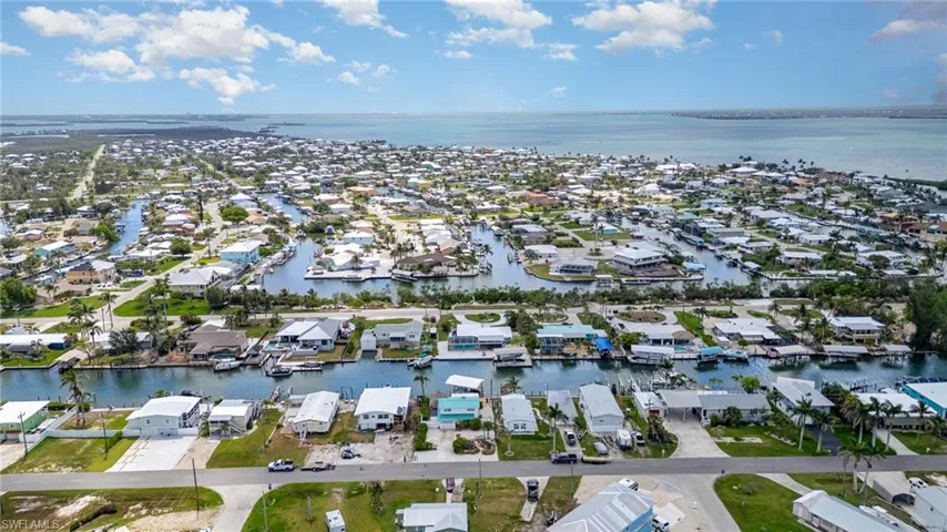Aerial view of property's location featuring nearby suburban area and a nearby body of water