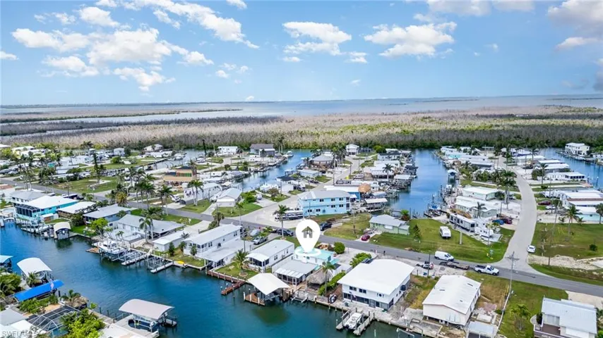 Aerial perspective of suburban area featuring a large body of water