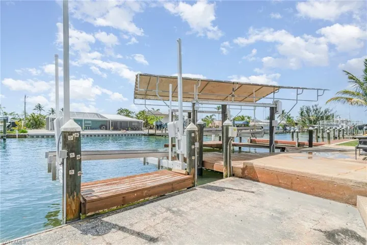 Dock area with boat lift and a water view