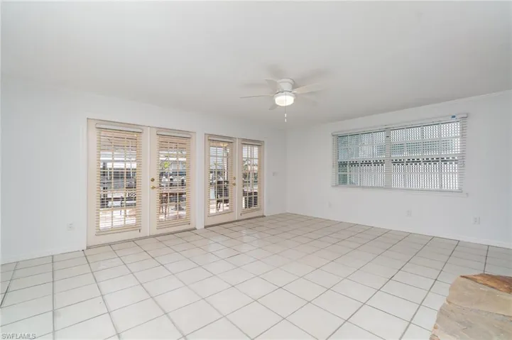Empty room with ceiling fan and baseboards