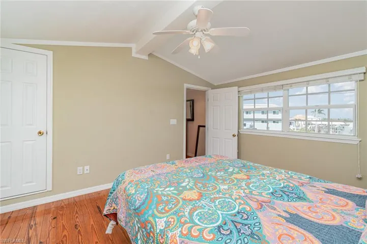 Bedroom featuring wood finished floors, ceiling fan, and baseboards