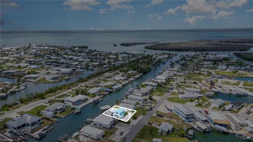 Aerial perspective of suburban area featuring a large body of water