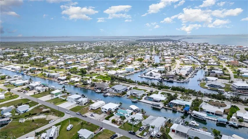 Aerial overview of property's location with nearby suburban area and a large body of water