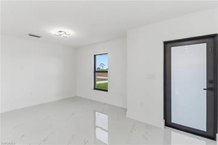 Unfurnished room with marble finish flooring and baseboards
