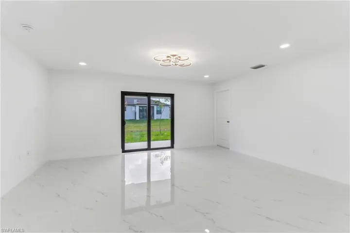 Unfurnished room with recessed lighting and light marble finish floors