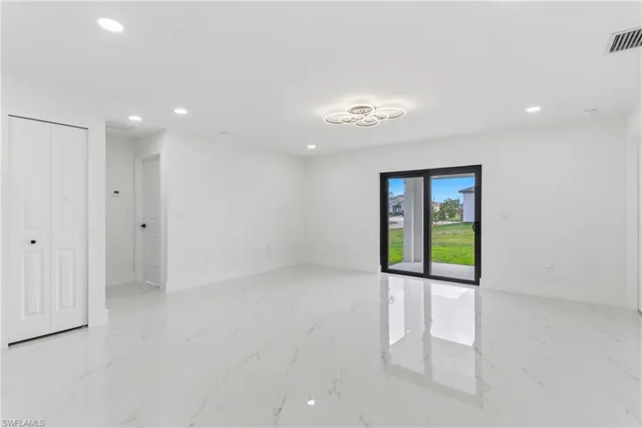 Empty room with recessed lighting and light marble finish flooring