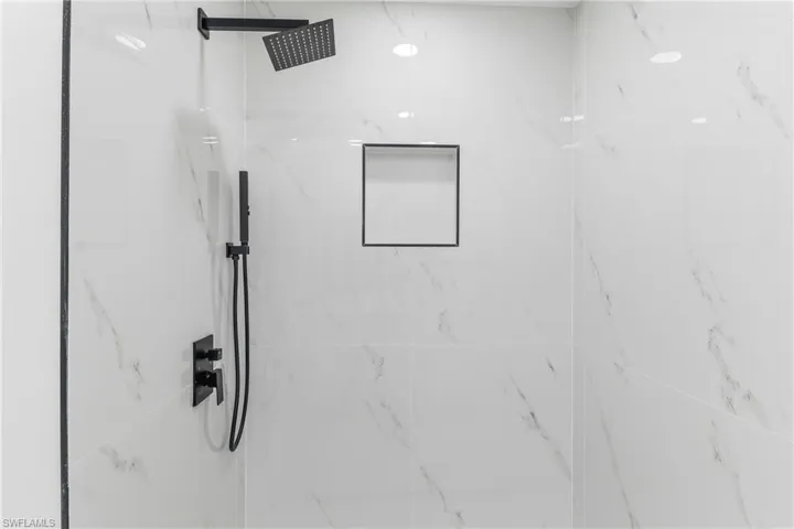 Bathroom view of a marble finish shower