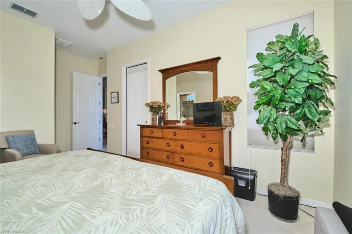 Bedroom featuring a ceiling fan and carpet