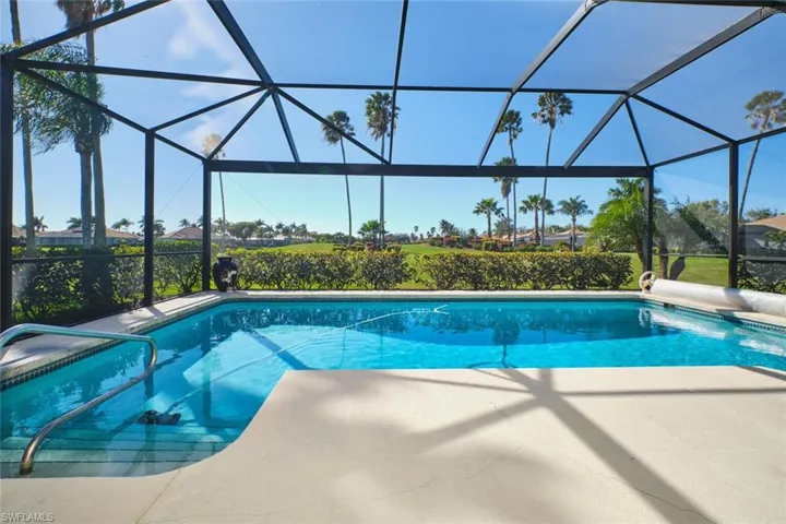 Swimming pool with a sunroom and a lanai